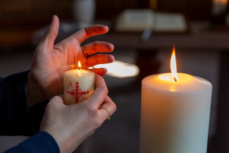 kleine und große Kerze mit Hand (Fundus)